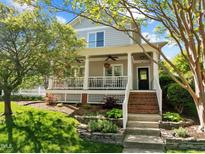 Charming two-story home boasts a welcoming front porch and beautifully landscaped front yard at 119 Weaver Mine Trl, Chapel Hill, NC 27517