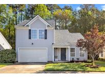 Charming home with grey siding, black shutters, garage, and a beautifully landscaped front yard at 1323 Fairmont St, Durham, NC 27713