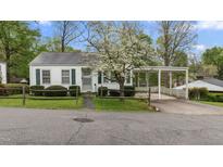 Charming one-story home with a quaint wooden fence and a covered carport for convenient parking at 1631 Sunset Ave, Henderson, NC 27536
