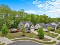 Beautiful home with a pool and a lovely landscaped yard on a sunny day at 190 Bingham Creek Dr, Garner, NC 27529