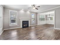 Inviting living room with a cozy fireplace and an abundance of natural light at 2113 Conroy Way, Willow Springs, NC 27592