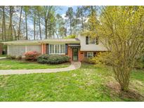 Charming two-story home with brick and vinyl siding and a well-maintained, landscaped front yard at 2415 Alpine Rd, Durham, NC 27707