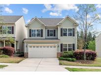 Charming two-story home featuring a two-car garage, complemented by lush landscaping and beautiful curb appeal at 2705 Evanston Ave, Durham, NC 27703