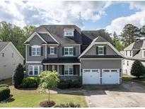 Charming two-story home features a well-manicured lawn, attached two-car garage, and lovely curb appeal at 2905 Pluton Pl, Rolesville, NC 27571