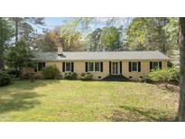 Charming one-story home with a well-manicured lawn and inviting entrance at 310 Edward Ln, Louisburg, NC 27549