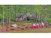 Charming brick home with a welcoming front porch and mature trees at 3417 Windmere Dr, Sanford, NC 27330