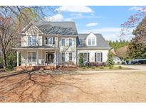 Beautiful two-story home with a charming front porch and well-maintained landscaping at 3908 Yateswood Ct, Raleigh, NC 27603