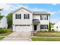 Charming two-story home with a well-maintained lawn, two-car garage, and classic black and white color scheme at 6102 Coronado Ln, Durham, NC 27713