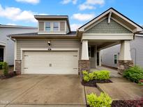 Charming home with a two-car garage and stone accents on the porch columns at 611 Atticus Way, Durham, NC 27703