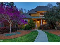 Charming two-story home with a walkway leading to the front door, enhanced by a vibrant tree at 10001 Sandcreek Ct, Chapel Hill, NC 27517