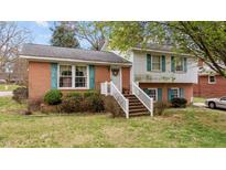 Charming brick and vinyl home featuring a welcoming front porch and well-maintained landscaping at 101 W Thorndale Dr, Oxford, NC 27565