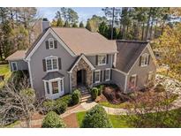Charming two-story home with a stone archway entrance and well-maintained landscaping at 102 Kamprath Pl, Cary, NC 27519
