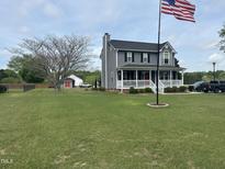 Charming two-story home with a spacious front yard and a welcoming front porch at 1020 Retriever Ln, Raleigh, NC 27603