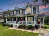 Charming two-story home featuring a welcoming front porch and well-maintained landscaping at 1020 Retriever Ln, Raleigh, NC 27603