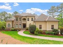 Inviting two-story home with stone accents, manicured lawn, and lush landscaping at 11 Swallow Tail Ct, Pittsboro, NC 27312
