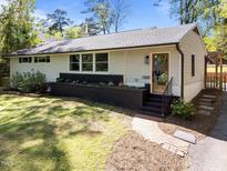 Charming single-story home with brick accents, landscaped beds, and a welcoming front entrance at 1307 Crabapple Ln, Raleigh, NC 27607