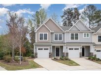 Charming townhome featuring a one car garage and neutral siding at 210 Silas St, Durham, NC 27705
