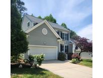 Two-story home featuring an attached garage, a well-maintained lawn, and traditional architecture with gray siding at 2424 Horizon Hike Ct, Raleigh, NC 27603