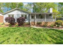 Charming single-story home with a welcoming front porch, landscaped yard and beautiful plantings at 313 Dunhagan Pl, Cary, NC 27511