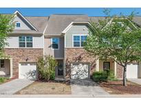 Charming townhome featuring stone accents, attached garage, and well-maintained landscaping at 36 Argonaut Dr, Durham, NC 27705