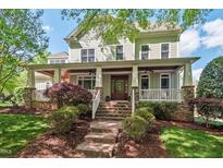 Beautiful two-story home featuring a charming front porch and landscaped yard with well maintained lawn and garden at 3616 Falls River Ave, Raleigh, NC 27614