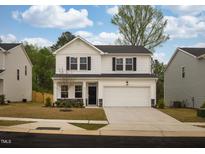 Charming two-story home with a two-car garage and manicured front lawn at 501 Willard Woods Dr, Wendell, NC 27591