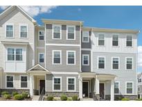 New townhome exterior showcasing a craftsman style with varied siding textures and stone accents at 5217 Invention Way, Raleigh, NC 27616