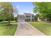 Charming two-story home with a two-car garage, well-maintained lawn, and a long driveway at 5424 Westminster Ln, Fuquay Varina, NC 27526