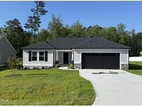 Traditional ranch style home featuring a well-manicured lawn and a two-car garage at 58 Heatherglenn Cir, Princeton, NC 27569