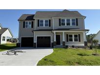 Charming two-story home featuring a spacious two-car garage and a well-manicured front lawn at 61 Heatherglenn Cir, Princeton, NC 27569