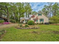Charming home with green shutters and a well-maintained yard surrounded by mature trees at 7110 Hunter Hill Rd, Rocky Mount, NC 27804