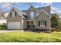Charming two-story home featuring a well-manicured lawn, attached garage, and inviting front entrance at 756 Rockville Rd, Wake Forest, NC 27587