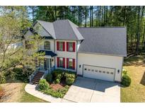 Beautiful two-story home featuring a well-manicured front yard and attached two-car garage at 103 Caymus Ct, Cary, NC 27519