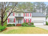 Charming two-story home with red shutters and well-manicured lawn offers classic curb appeal at 103 Caymus Ct, Cary, NC 27519