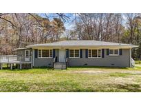 Charming single-story house featuring blue shutters and a well-maintained front yard at 13832 Nc 96 N Hwy, Zebulon, NC 27597