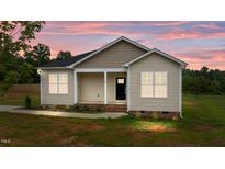 Charming one-story home featuring neutral siding, black front door and a cozy covered porch at 170 Brookhaven Dr, Spring Hope, NC 27882