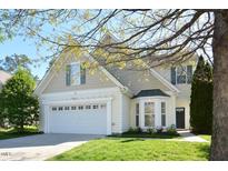 Charming two-story home featuring a manicured lawn, attached garage, and delightful bay window at 1914 Woodsdale Dr, Durham, NC 27703
