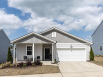 Charming single-story home featuring a covered porch and a well-maintained front yard at 3521 Strawberry Patch Row, Raleigh, NC 27604