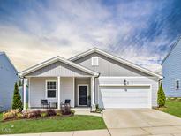 Charming single-story home featuring a welcoming front porch, attached garage, and well-maintained landscaping at 3521 Strawberry Patch Row, Raleigh, NC 27604