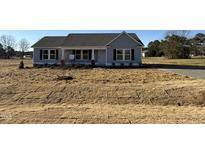 Charming single-story home with a manicured front yard, inviting entrance, and classic architectural details at 48 Pate Landing Dr, Selma, NC 27576