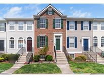 Charming brick-front townhome featuring a well-manicured lawn and color-coordinated shutters at 5505 Crabtree Park Ct, Raleigh, NC 27612