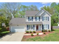 Charming two-story home with well-manicured lawn, attached garage, and inviting curb appeal at 600 Old Farm Rd Rd, Graham, NC 27253