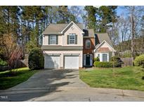 Charming two-story home featuring a two-car garage, green shutters, and lush front lawn at 616 Branchview Dr, Durham, NC 27713