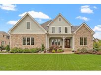 Charming stone and siding home with a well-manicured lawn and inviting curb appeal at 749 Golfers Vw, Pittsboro, NC 27312