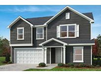 Charming two-story home with a front-facing two-car garage and professionally landscaped yard at 86 Orchard St, Lillington, NC 27546