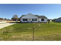 Charming single-story home featuring a well-maintained lawn and traditional architectural details at 99 Pate Landing Dr, Selma, NC 27576