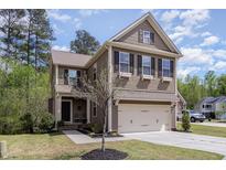 Charming two-story home with a two-car garage and beautifully landscaped front yard at 104 Lowe Wood Ct, Durham, NC 27703