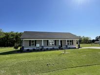 Charming single-story home with well-maintained lawn and inviting front porch, creating a welcoming curb appeal at 108 Pate Landing Dr, Selma, NC 27576