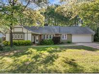 Charming one-story home with a well-maintained lawn and attached two car garage at 1304 Deboy St, Raleigh, NC 27606
