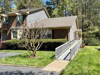 Charming exterior featuring brick and siding, complemented by a well-maintained lawn and accessible ramp at 1308 Oakridge Ave # 3, Henderson, NC 27536